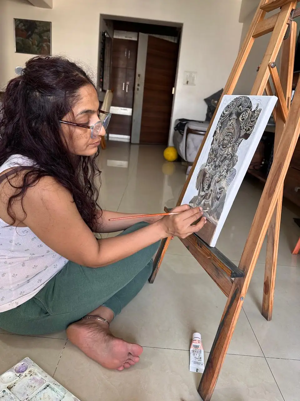 Vibhuti Mehta painting at the easel in her studio